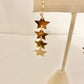 Dangly gold star earrings
